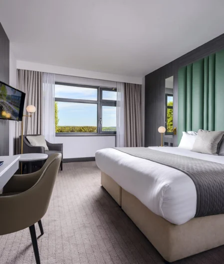 Elegant hotel room with king bed, scenic views, and modern amenities for a comfortable stay.