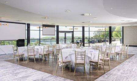 Elegant hotel conference room with panoramic scenic views, modern decor, and luxurious seating for events or meetings.