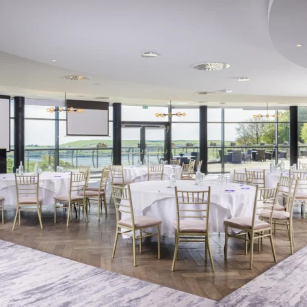 Elegant hotel conference room with panoramic scenic views, modern decor, and luxurious seating for events or meetings.