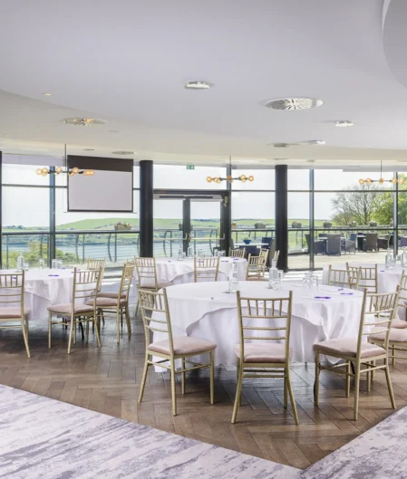 Elegant hotel conference room with panoramic scenic views, modern decor, and luxurious seating for events or meetings.