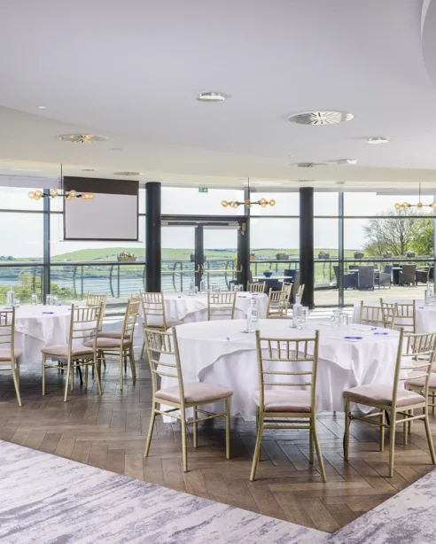 Elegant hotel conference room with panoramic scenic views, modern decor, and luxurious seating for events or meetings.