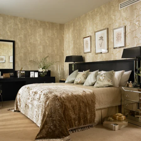 Elegant hotel room with king-size bed, plush pillows, chic decor, large mirror, and ambient lighting for a luxurious stay.