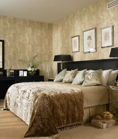 Elegant hotel room with king-size bed, plush pillows, chic decor, large mirror, and ambient lighting for a luxurious stay.
