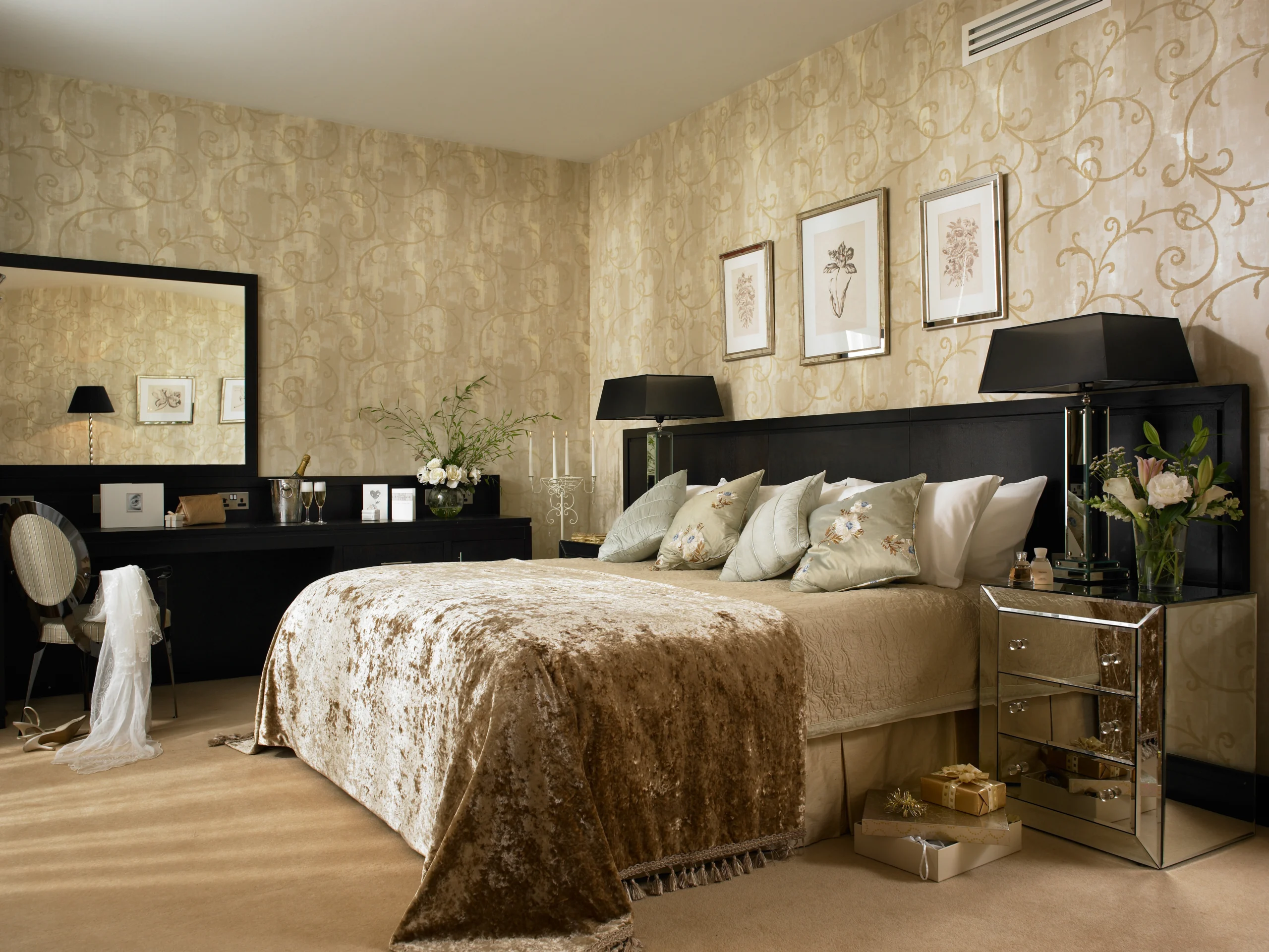 Elegant hotel room with king-size bed, plush pillows, chic decor, large mirror, and ambient lighting for a luxurious stay.