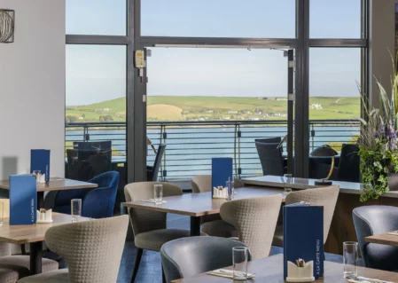 Relaxing hotel dining with scenic seaside view, elegant seating, and modern decor, perfect for a tranquil retreat.