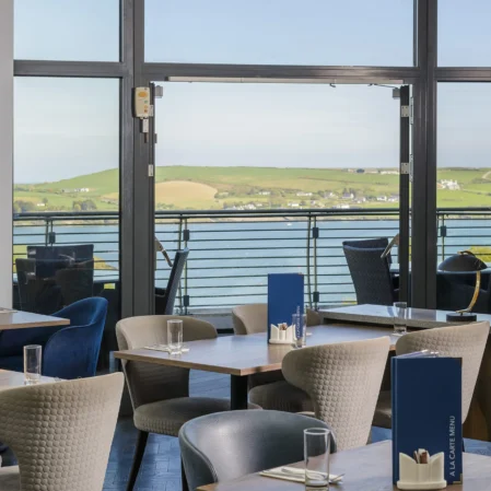 Relaxing hotel dining with scenic seaside view, elegant seating, and modern decor, perfect for a tranquil retreat.