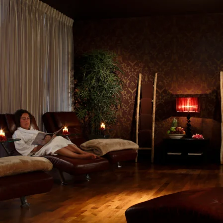 Relaxing hotel spa lounge with cosy seating, warm lighting, plush robes, and serene ambience for ultimate comfort.