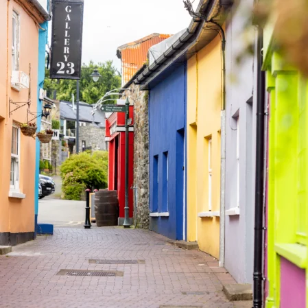 Colourful street with charming shops and vibrant facades, offering a delightful experience for hotel guests in a lively neighbourhood.