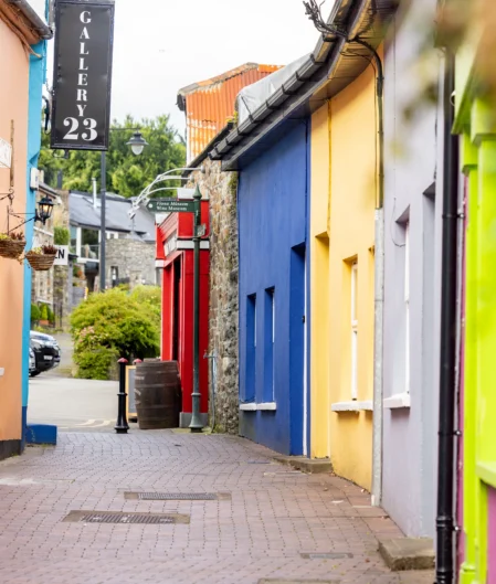 Colourful street with charming shops and vibrant facades, offering a delightful experience for hotel guests in a lively neighbourhood.