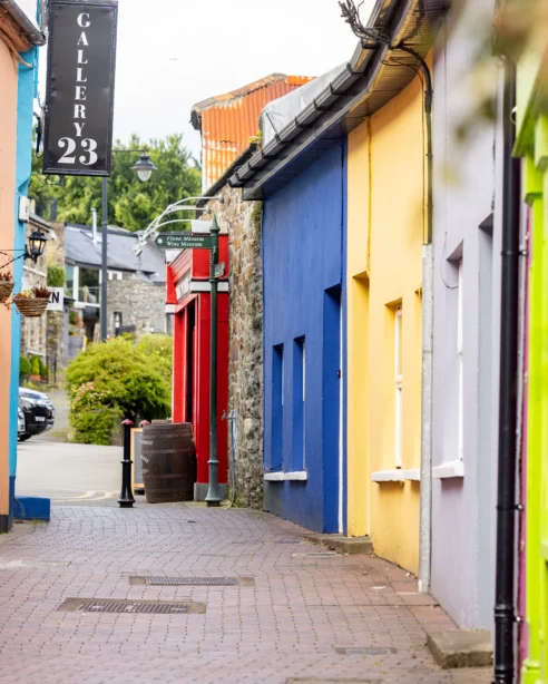 Colourful street with charming shops and vibrant facades, offering a delightful experience for hotel guests in a lively neighbourhood.