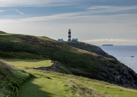 Scenic coastal view with a lighthouse near a golf course, perfect for relaxation and leisure activities at the hotel.