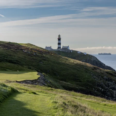 Scenic coastal view with a lighthouse near a golf course, perfect for relaxation and leisure activities at the hotel.