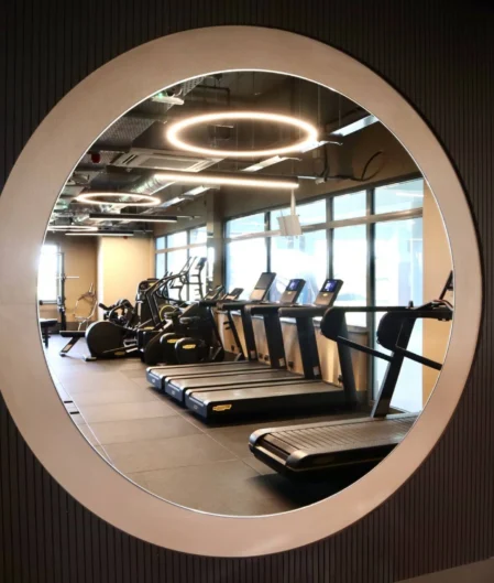 Modern hotel gym with treadmills, exercise bikes, and ambient lighting for a revitalising workout experience.