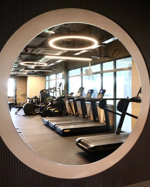 Modern hotel gym with treadmills, exercise bikes, and ambient lighting for a revitalising workout experience.