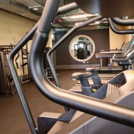 Modern hotel gym with treadmills and exercise bikes offering a bright, spacious fitness experience.