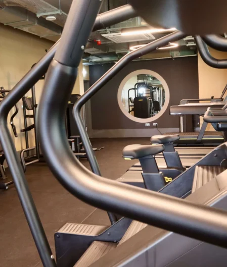 Modern hotel gym with treadmills and exercise bikes offering a bright, spacious fitness experience.