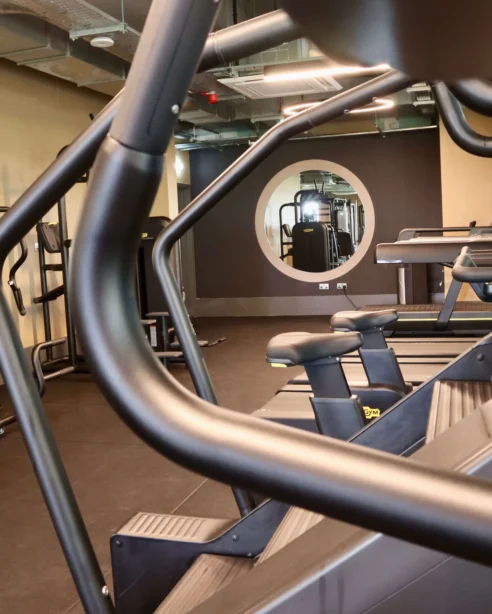 Modern hotel gym with treadmills and exercise bikes offering a bright, spacious fitness experience.
