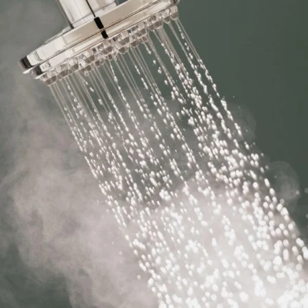Luxurious rainfall shower with cascading water and soothing steam, offering a relaxing spa-like experience.