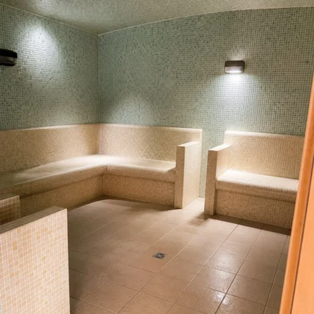 Luxurious hotel steam room with cosy seating and ambient lighting for relaxation and rejuvenation.