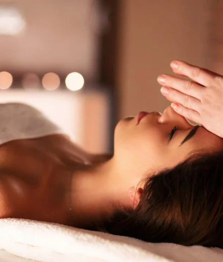 Guest enjoys a soothing massage in the tranquil hotel spa, surrounded by warm candlelight and soft towels. Relaxation promised.